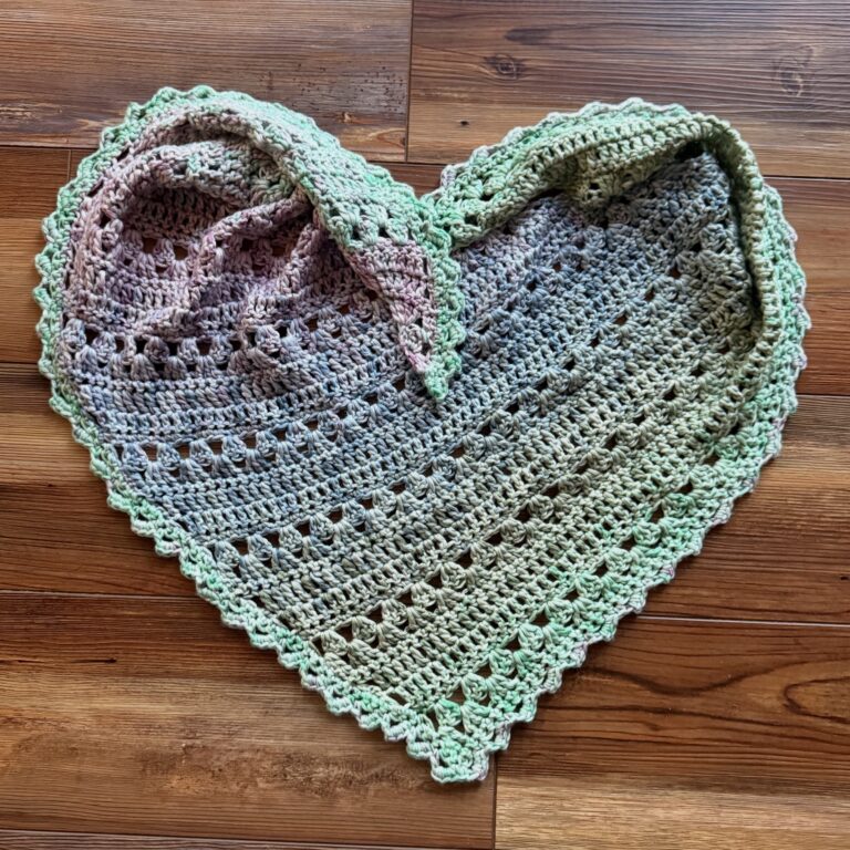 Crocheted scarf arranged in the shape of a heart.