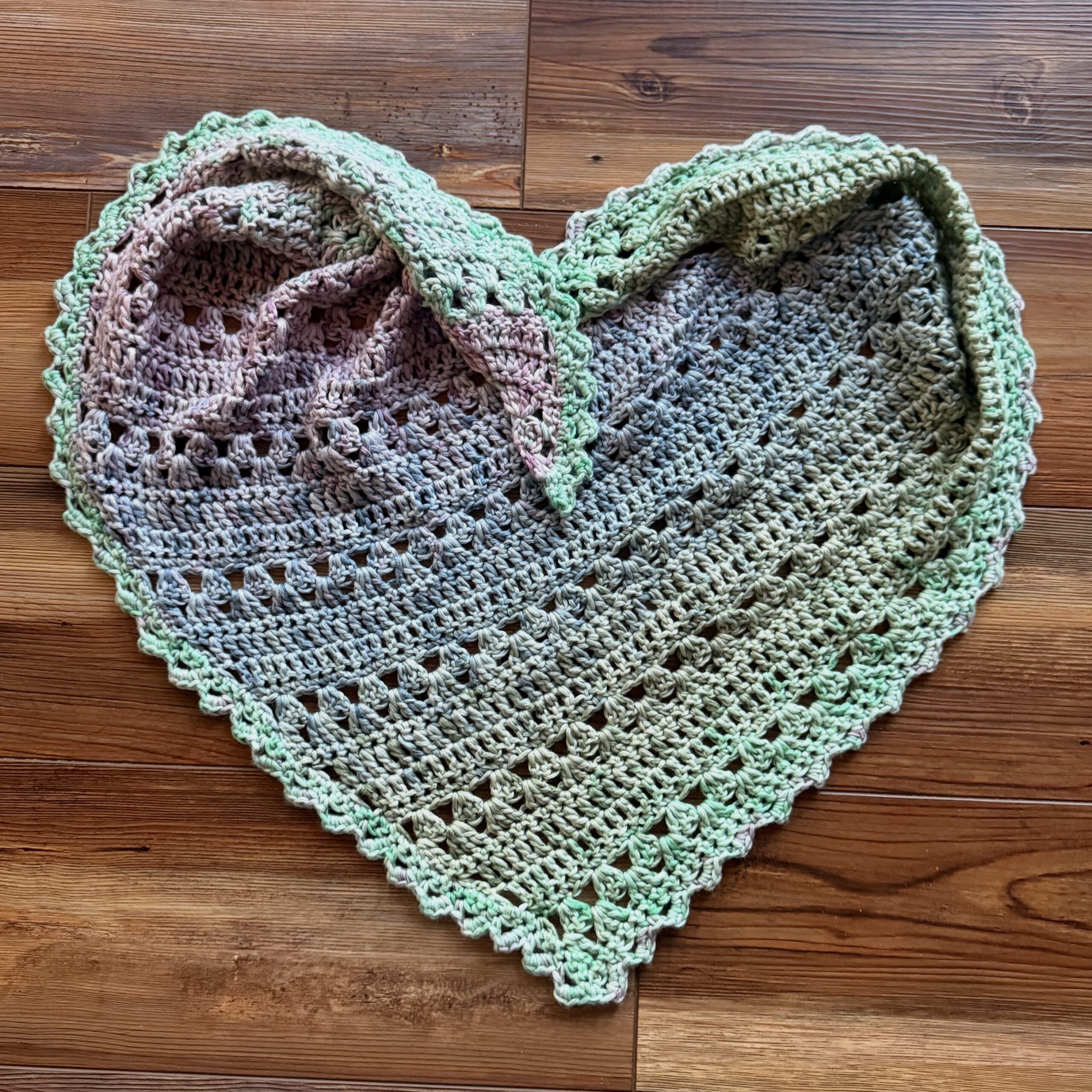 Crocheted scarf arranged in the shape of a heart.
