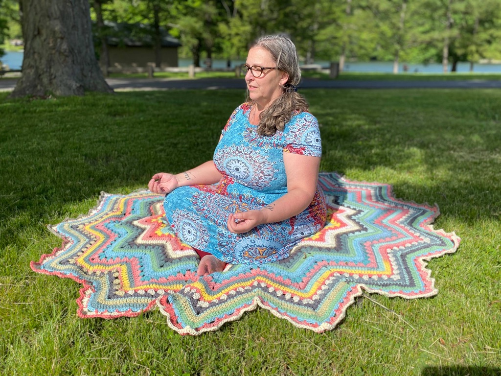 Betty McKnit meditating on a 6-Day Superstar Blanket