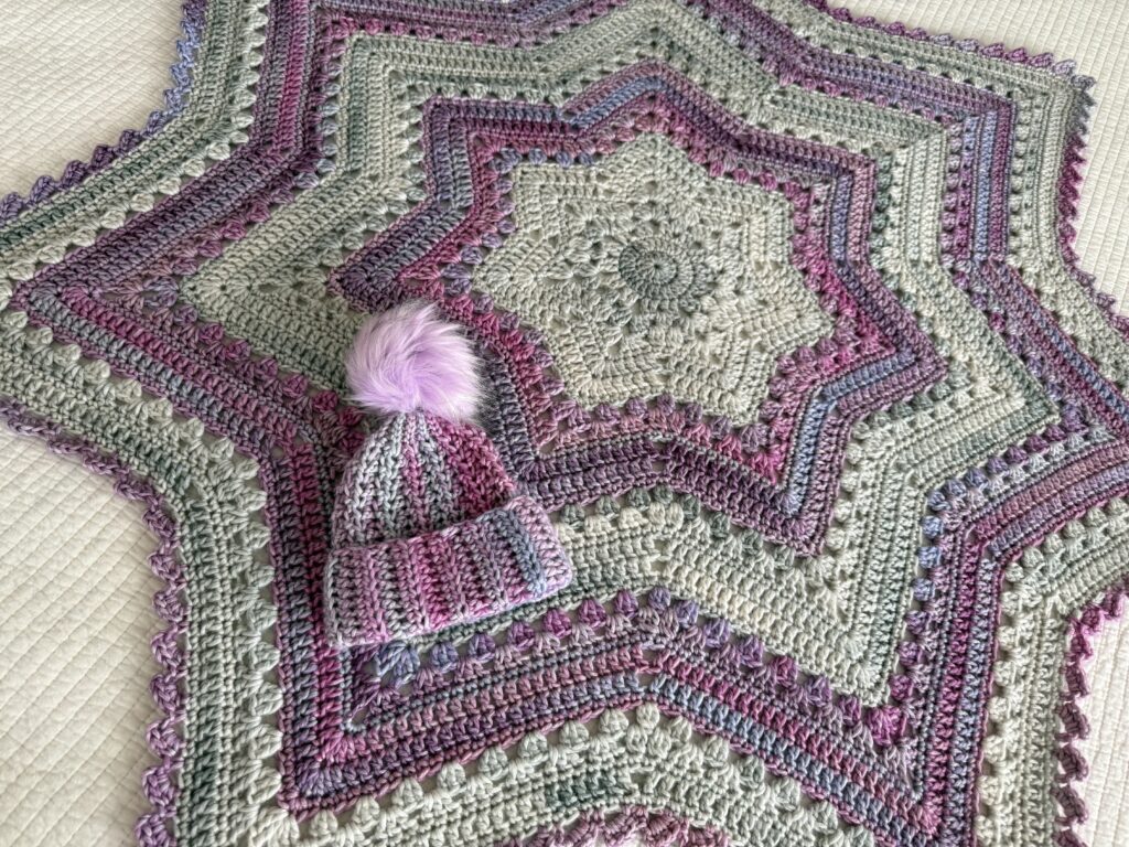 6-Day Star Blanket in baby size with baby pom-pom beanie