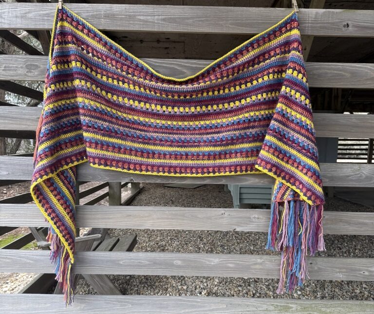 Colorful wrap hanging on wooden siding outdoors