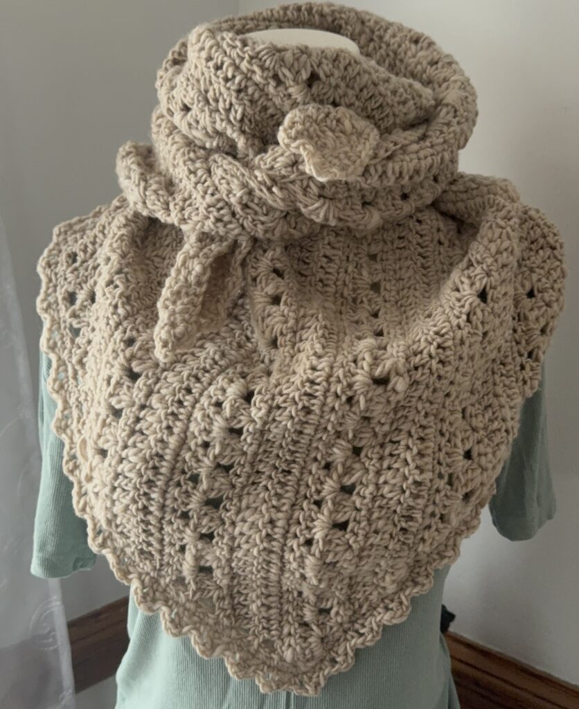 Tranquil Tides Scarf modeled on mannequin shown in cream colored bulky yarn.