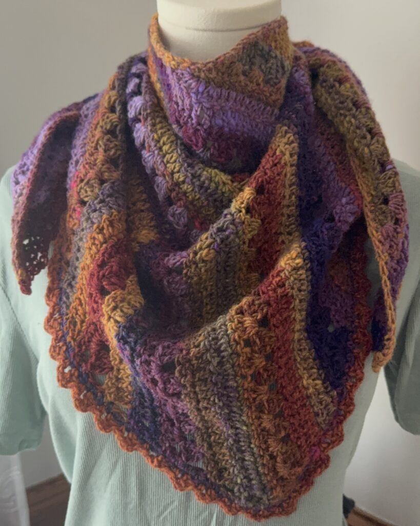 Colorful scarf modeled on body form.