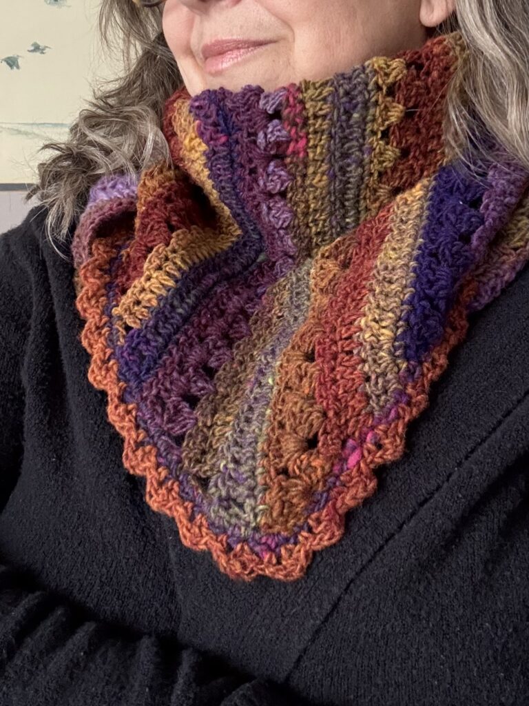 Colorful triangular scarf with picot border modeled.